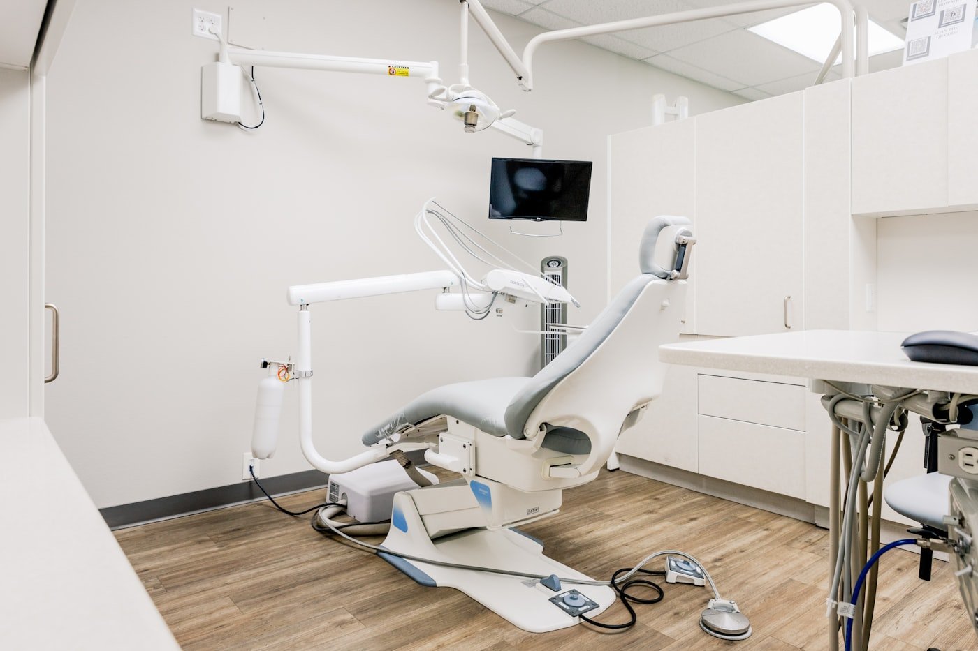 A modern treatment room with a dental chair